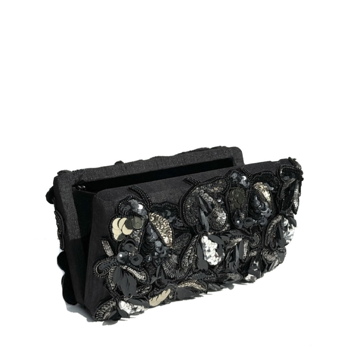 A black fabric clutch purse featuring elaborate 3D floral appliqués with black, silver, and white sequins and beads, set against a plain white background.