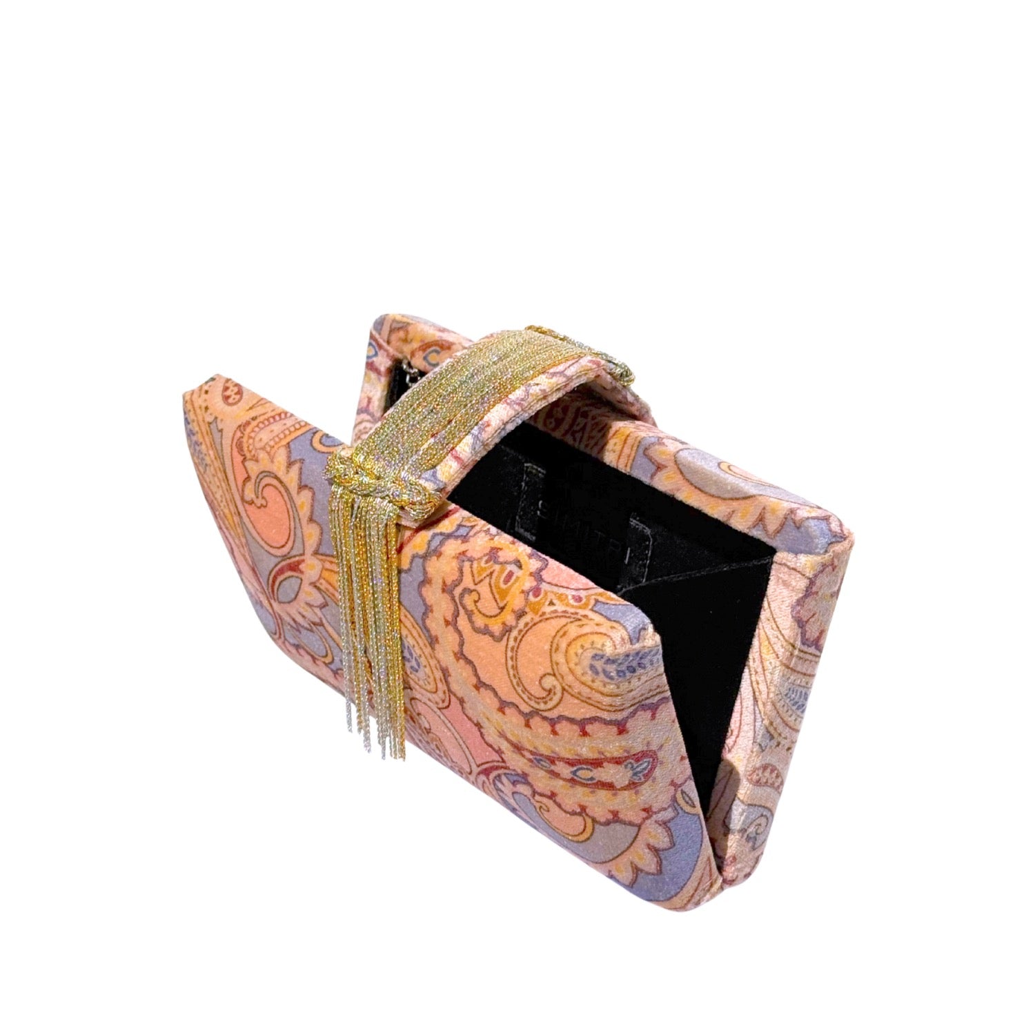 Printed clutch bag with paisley pattern and gold tassel on a white background